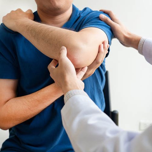 Physiotherapist stretching an elbow